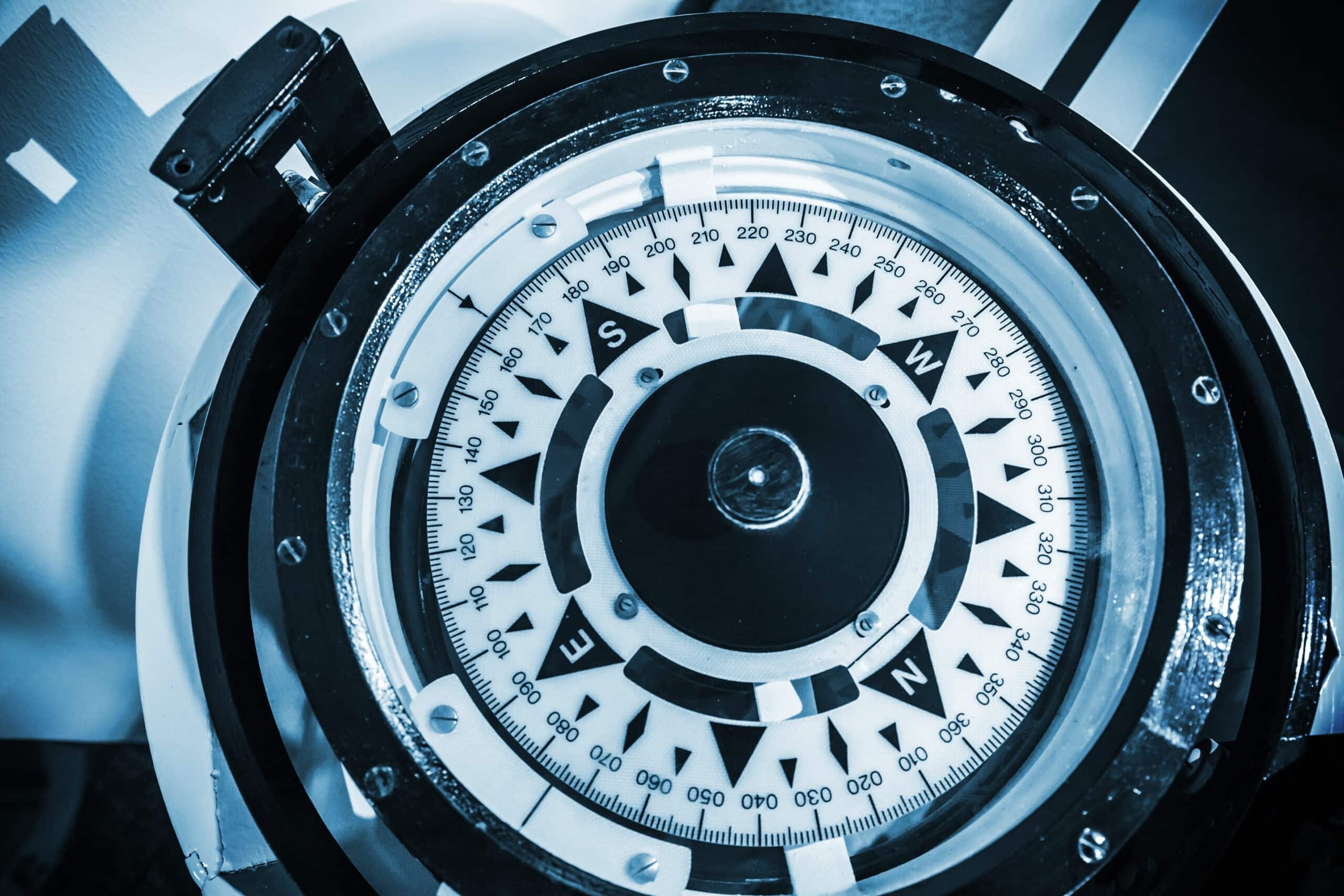 Naval compass. Blue toned monochrome close-up photo